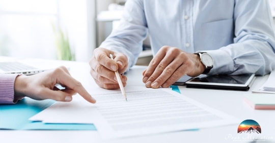 Two people reading contract, pointing and rewriting