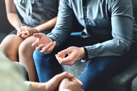 Couple on couch undergoing counseling